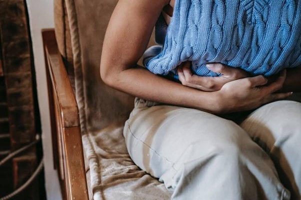 Women holding stomach suffering from IBS